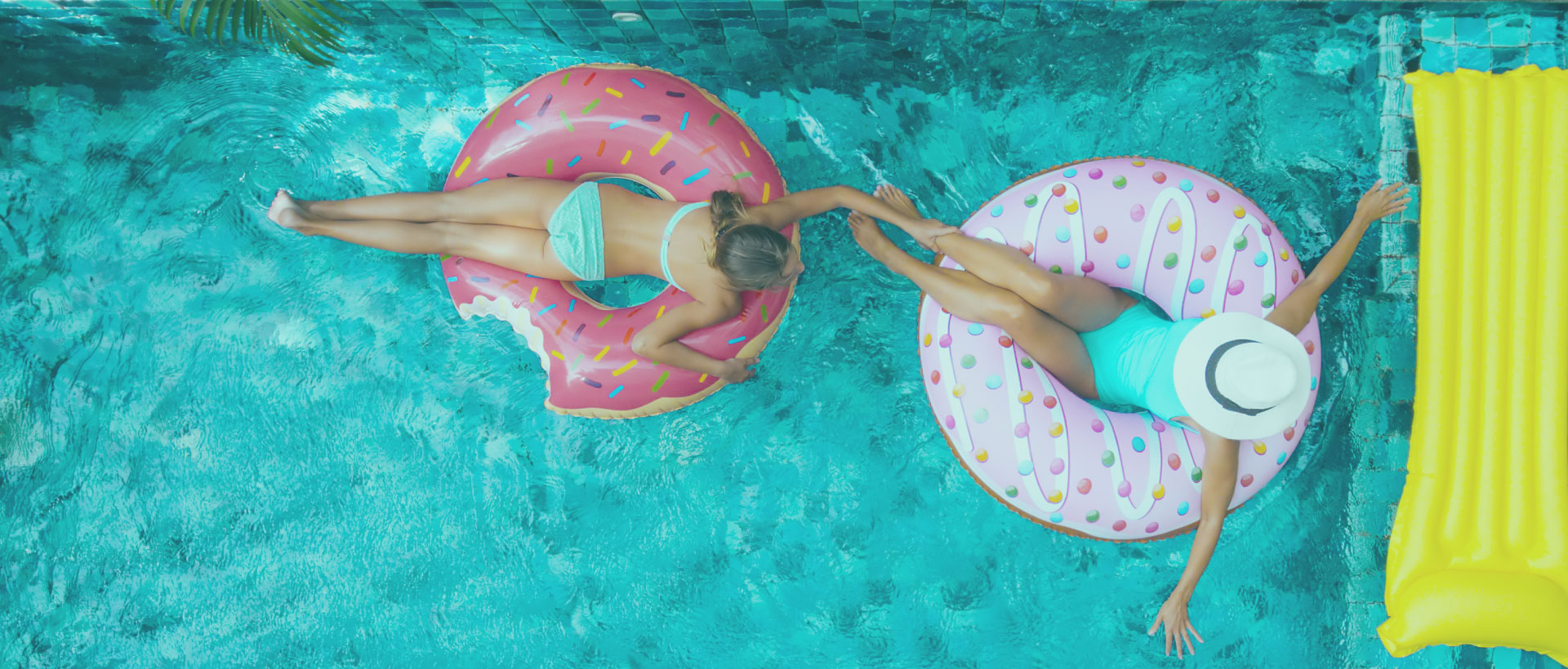 women floating in pool